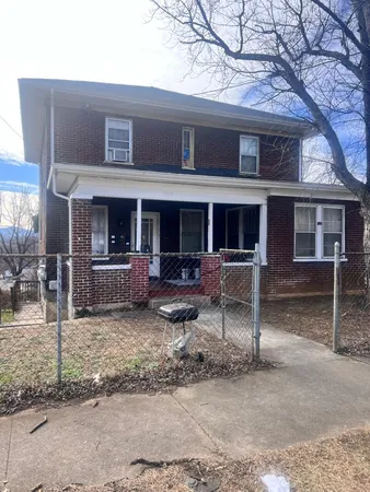 a view of a house with a patio and a yard