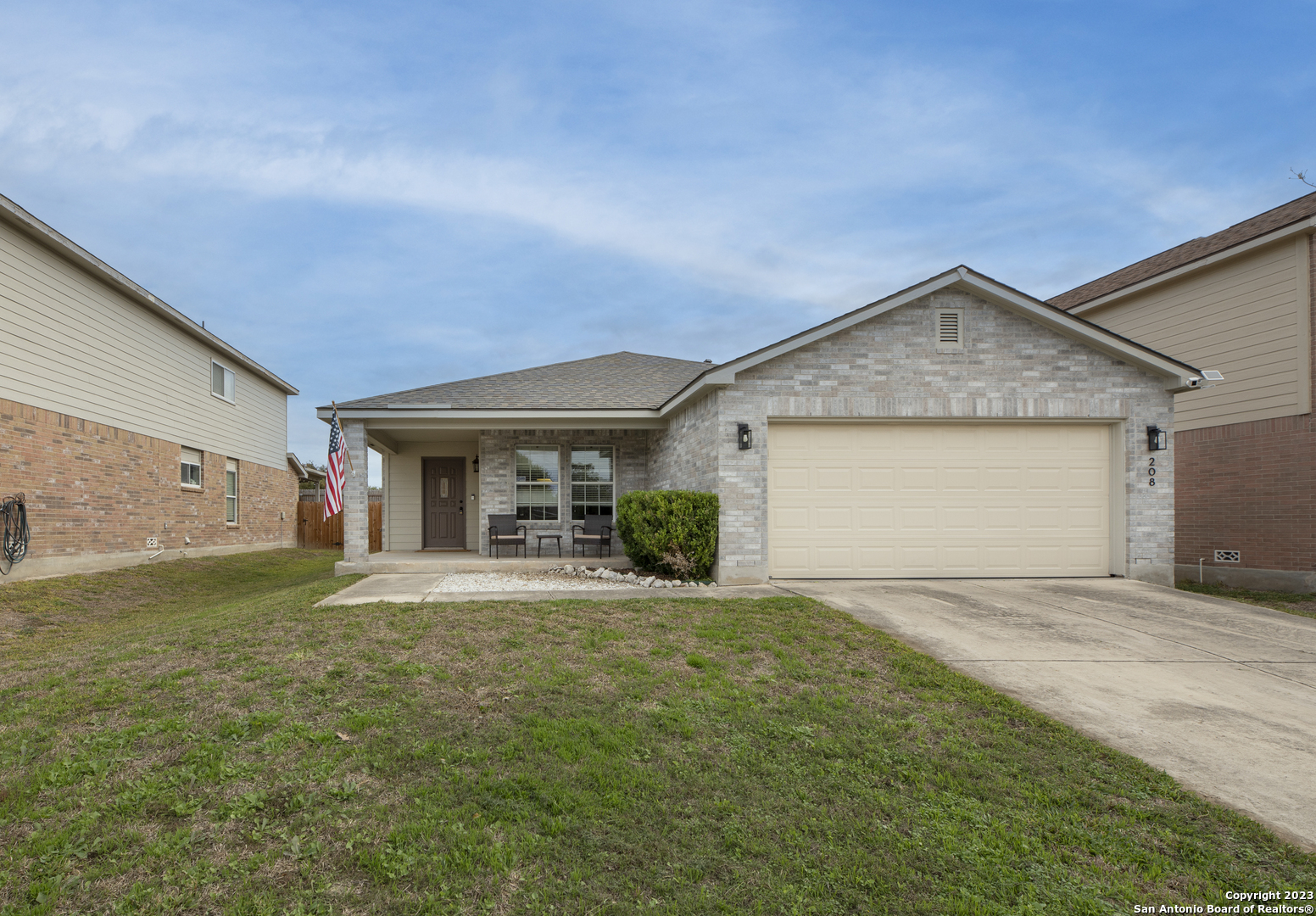 a view of a house with a yard and garage