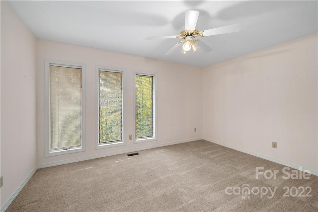 592 Mouzon Road Waynesville, NC 28785 - Photo 11 of 38 an empty room with windows and fan