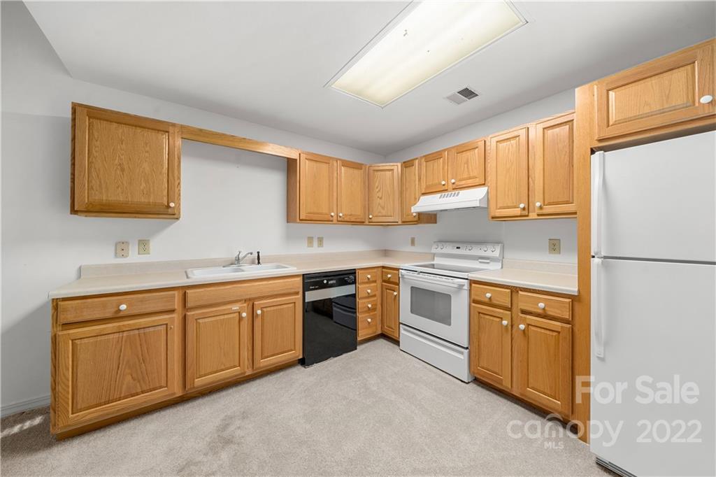 592 Mouzon Road Waynesville, NC 28785 - Photo 29 of 38 a kitchen with granite countertop a sink stainless steel appliances and window