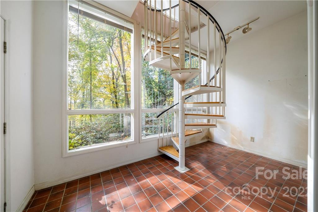 592 Mouzon Road Waynesville, NC 28785 - Photo 32 of 38 an empty room with wooden floor fan and windows
