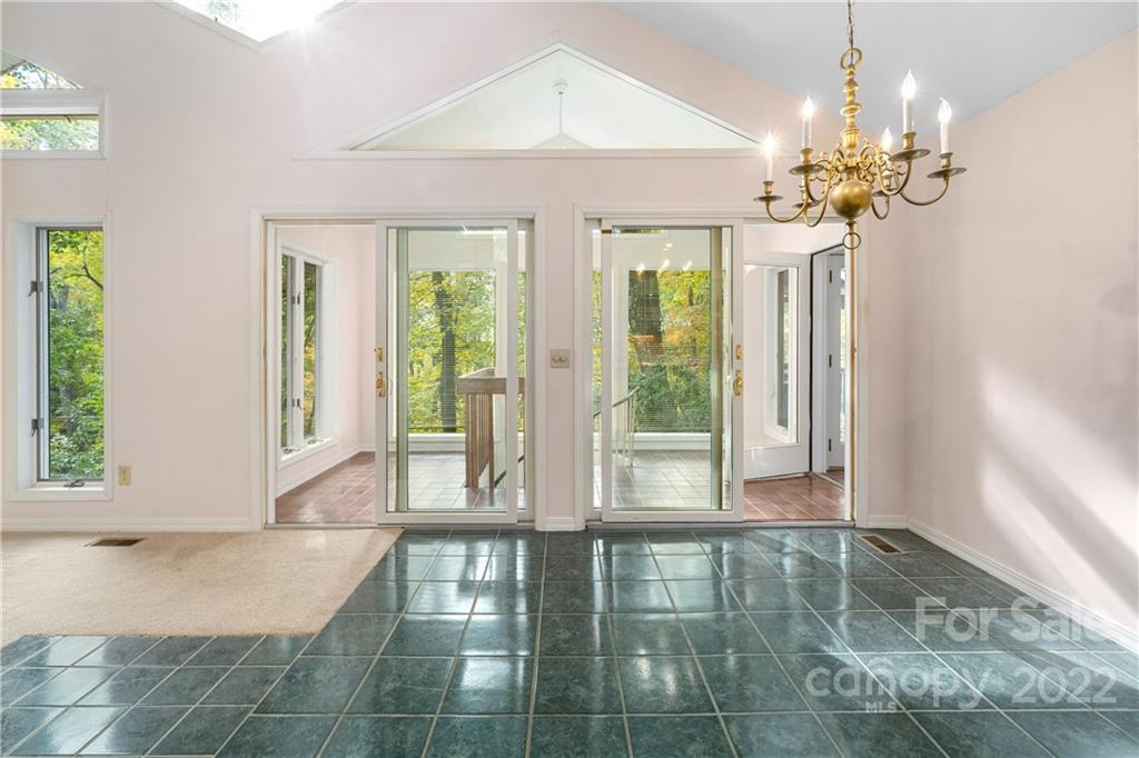 592 Mouzon Road Waynesville, NC 28785 - Photo 6 of 38 a view of a room with large windows and chandelier