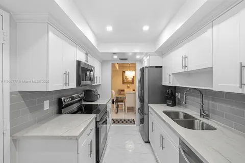 a kitchen that has a sink and a stove in it