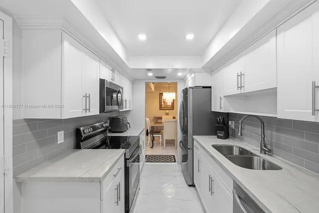 a kitchen that has a sink and a stove in it