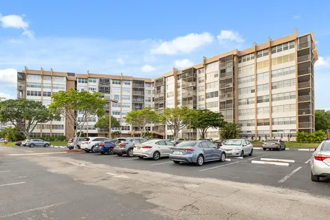 a city street lined with parked cars and buildings