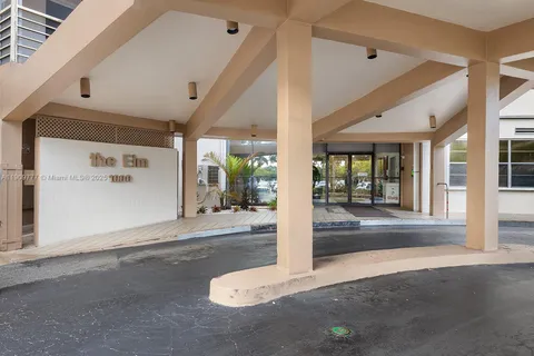 a view of a hallway with floor to ceiling window and dining room