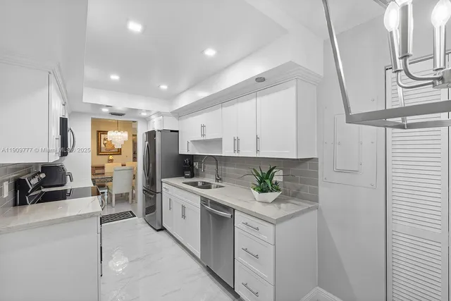 a kitchen with stainless steel appliances granite countertop a sink stove and cabinets