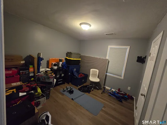 a room with furniture a rug and gym equipment