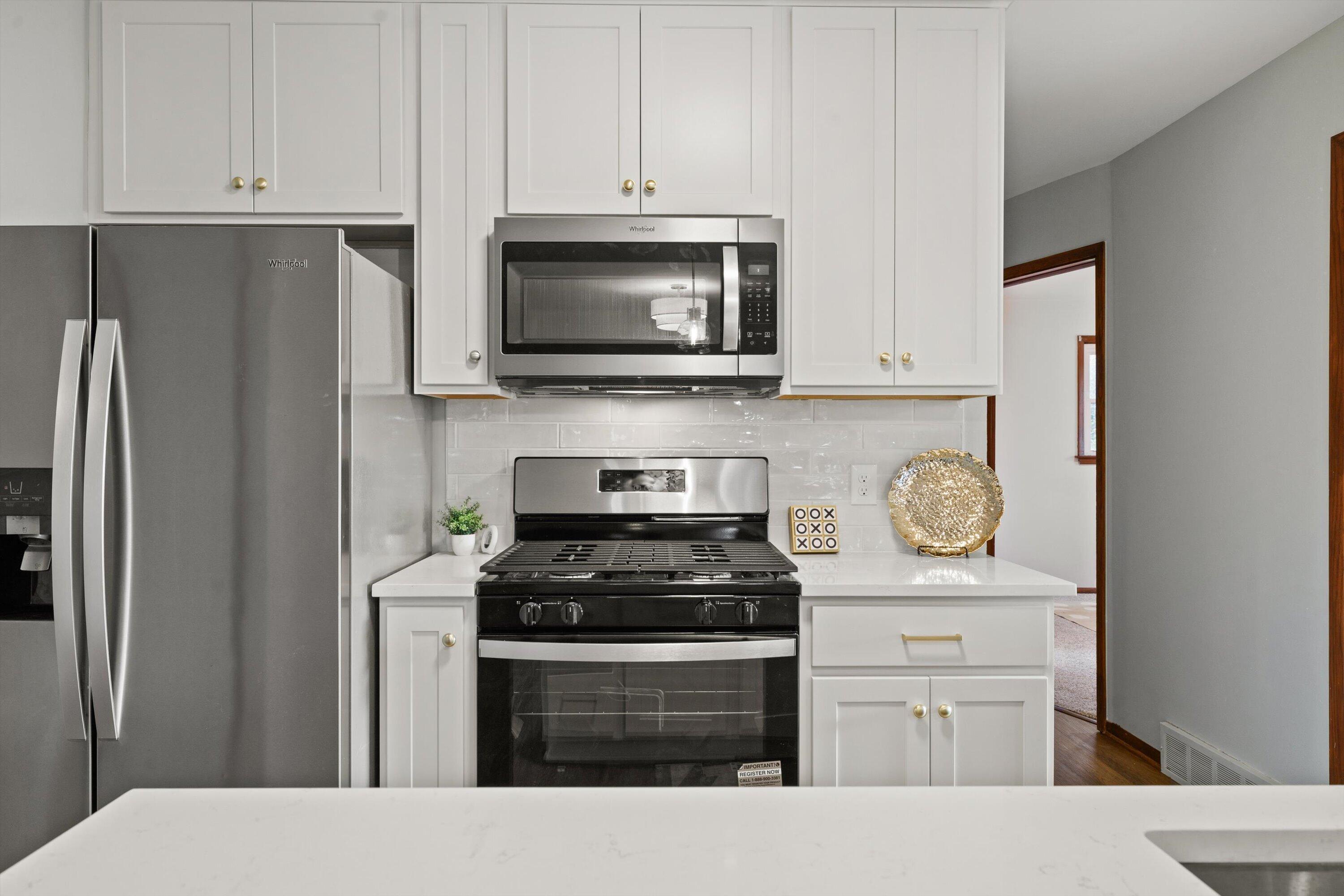 726 Royal Park Road Caledonia, WI 53402 - Photo 22 of 29 Modern finishes, tile backsplash, and ample cabinetry give this kitchen a clean, refreshed feel