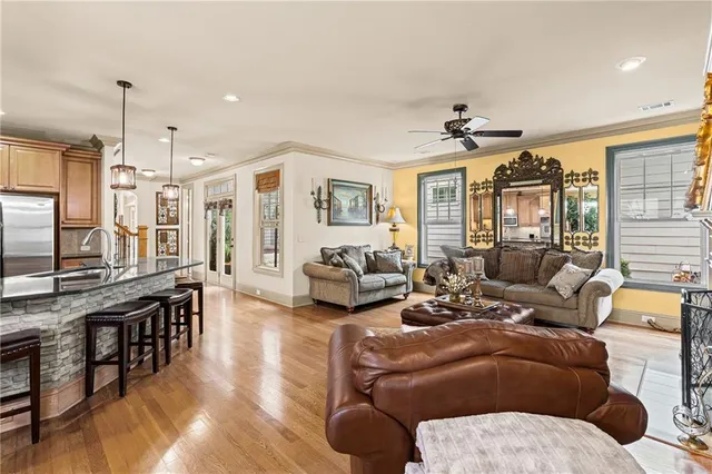 a kitchen with stainless steel appliances granite countertop a stove a kitchen island a table and chairs