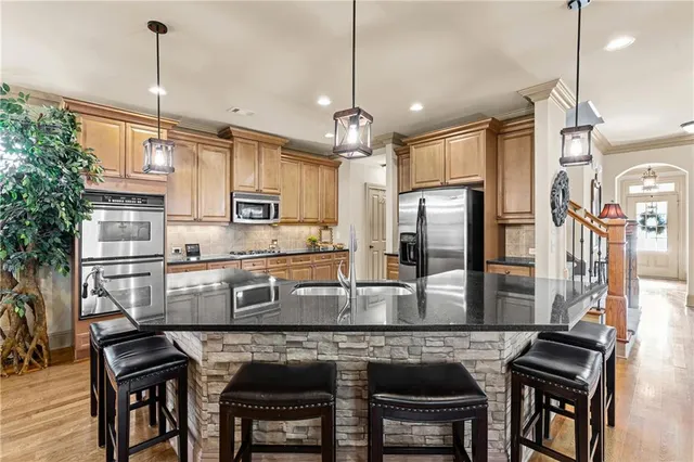 a kitchen with lots of counter space a sink and appliances