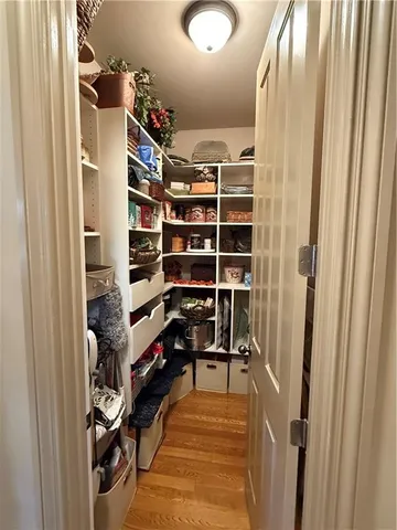 a view of a hallway with wooden floor and stairs