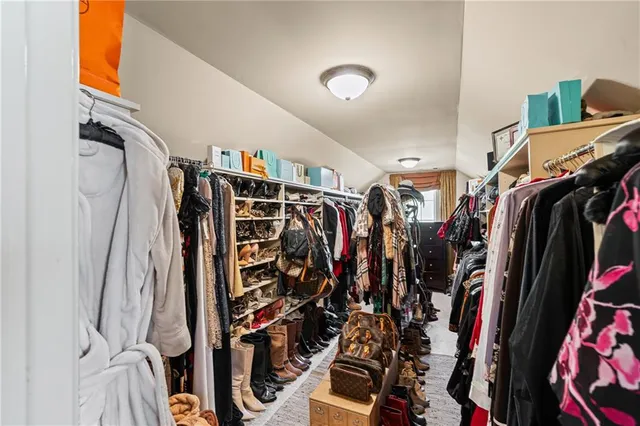 a view of a patio with couches table and chairs under an umbrella