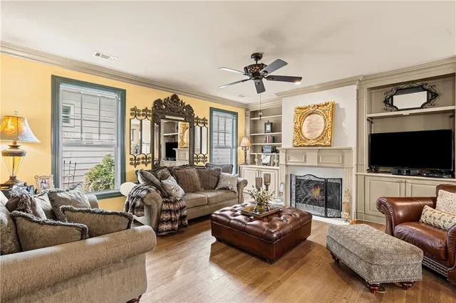 a living room with furniture and a view of kitchen