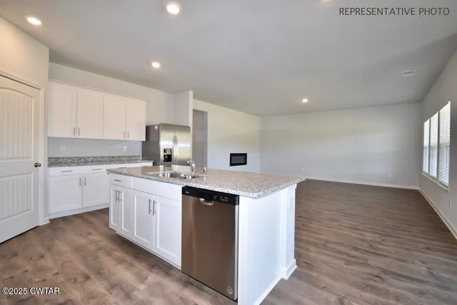 a kitchen with a sink stove and cabinets