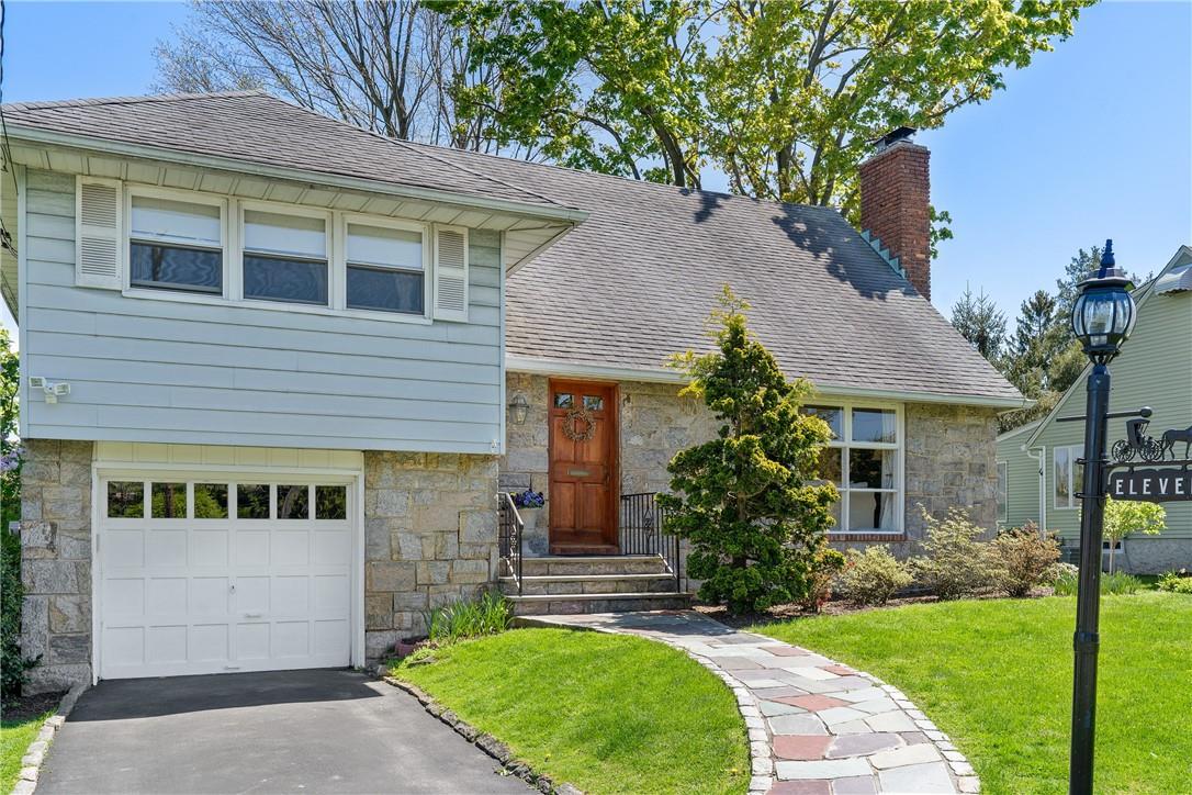11 Pasadena Road Bronxville, NY 10708 - Photo 1 of 1 a front view of a house with a garden and yard