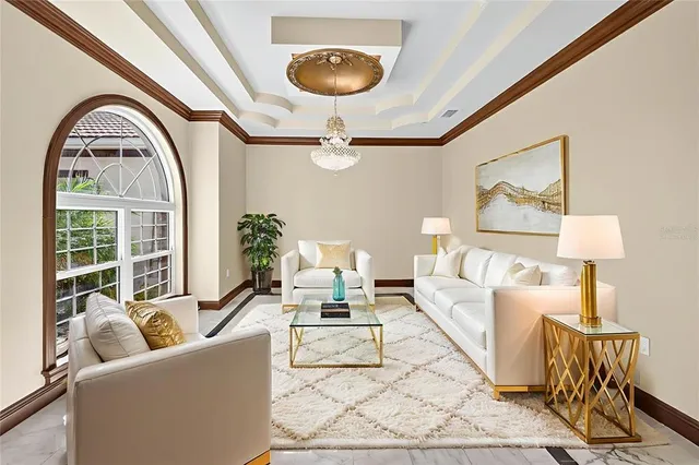 a bedroom with a large bed and a chandelier