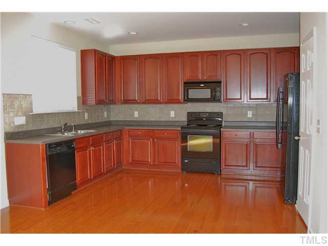 117 Steam Engine Way Garner, NC 27529 - Photo 5 of 21 This kitchen is so spacious! Notice the beautiful hardwood flooring, abundance of cabinet space, pantry, black appliances, neutral & classic laminate countertops, recessed lighting & more!
