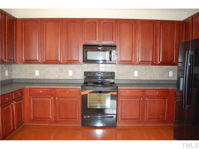 117 Steam Engine Way Garner, NC 27529 - Photo 6 of 21 Raised panel cabinets and beautiful neutral tile backsplash ... Check out the great countertop space!