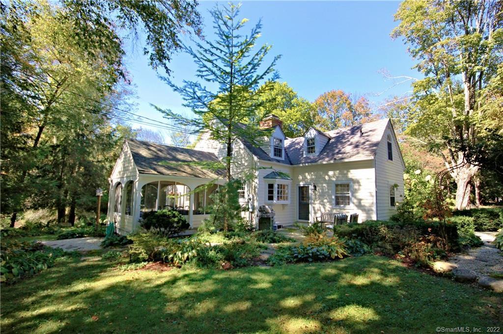a front view of a house with a yard and potted plants