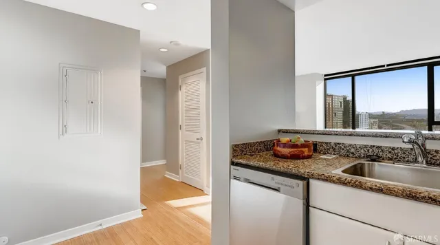 a kitchen with stainless steel appliances granite countertop a stove a microwave and a refrigerator