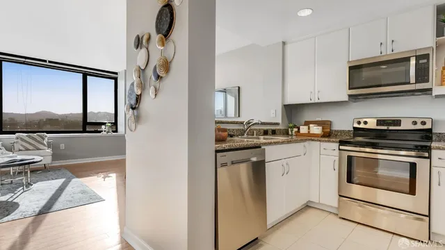 a white refrigerator freezer and a stove sitting inside of a kitchen