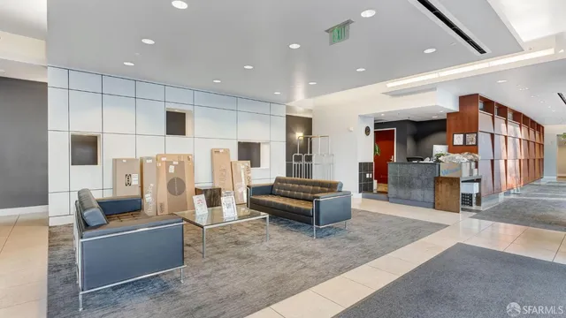 a living room with large window and a wooden floor
