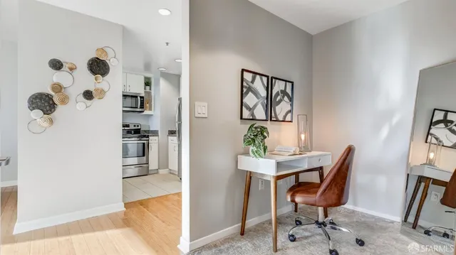 a view of a workspace room with furniture and wooden floor