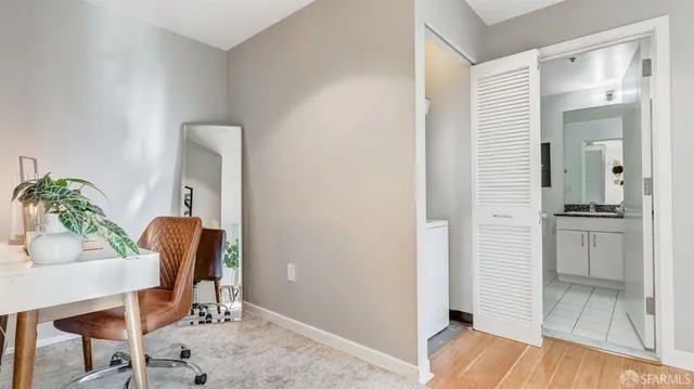 a view of a hallway with dining room and wooden floor