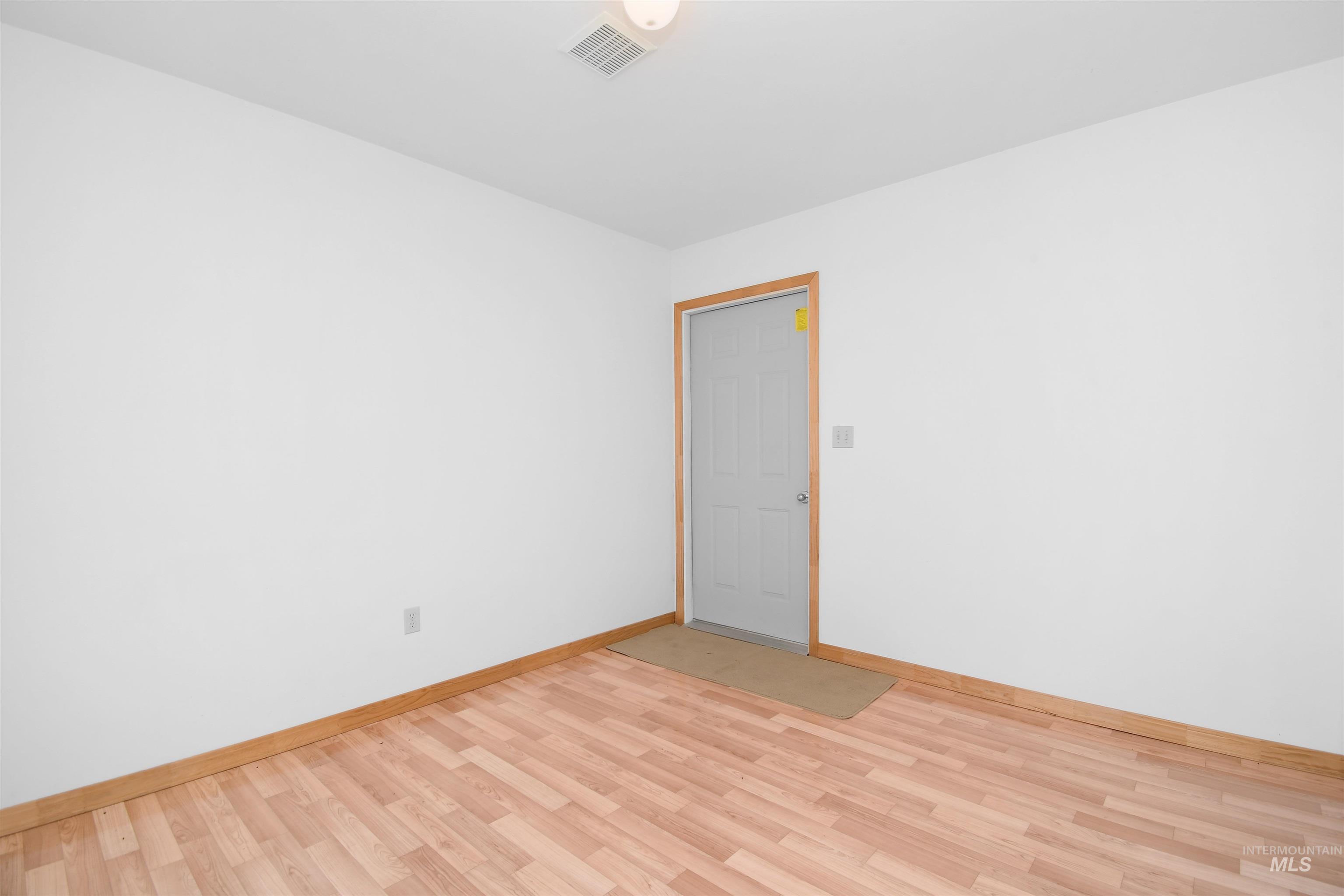 11375 Timber Butte Road Sweet, ID 83670 - Photo 40 of 49 Room featuring light wood-finish flooring, white walls, and wood trim