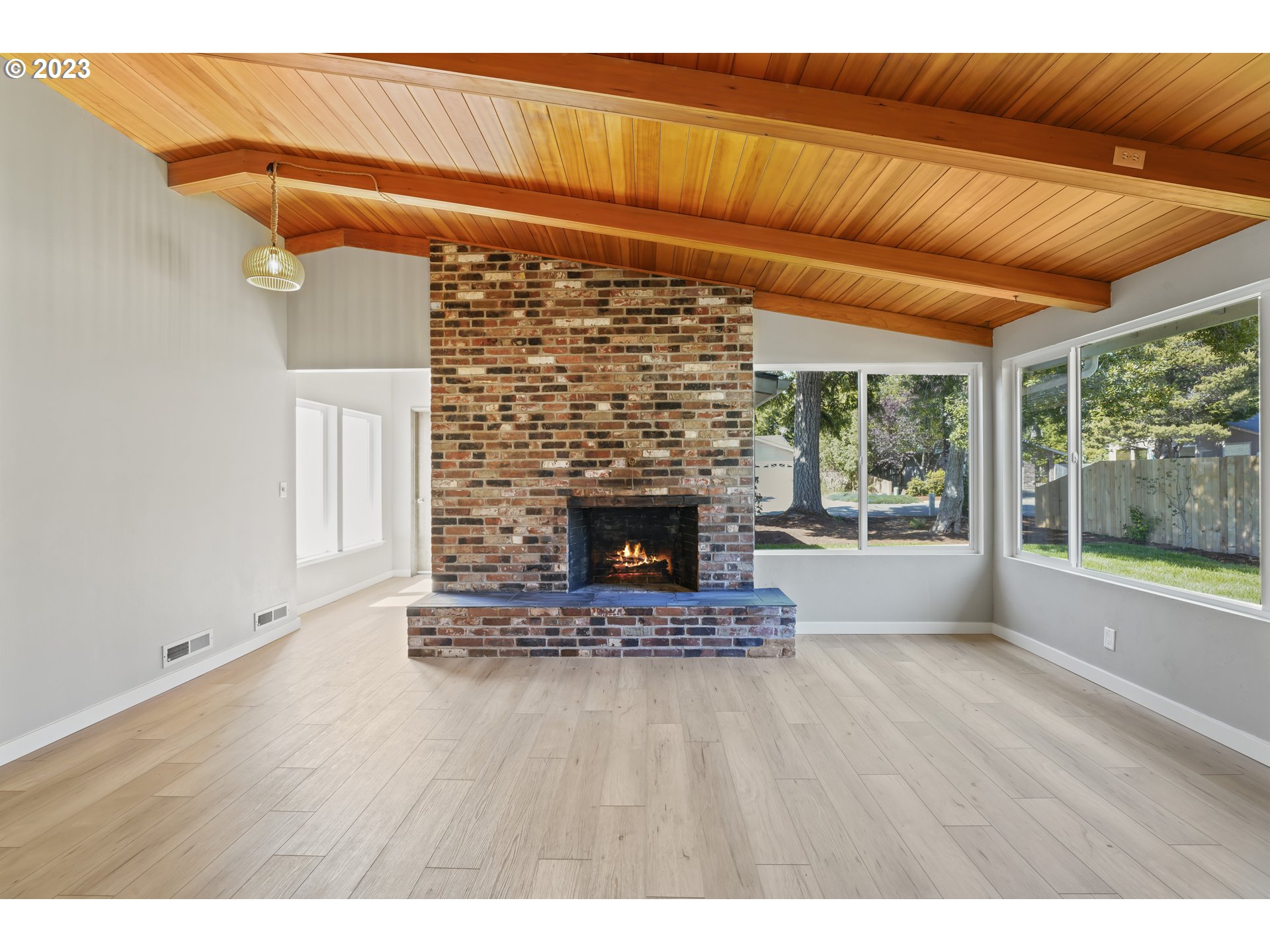 2232 24th Street Florence, OR 97439 - Photo 11 of 38 a view of an empty room with a fireplace and a window