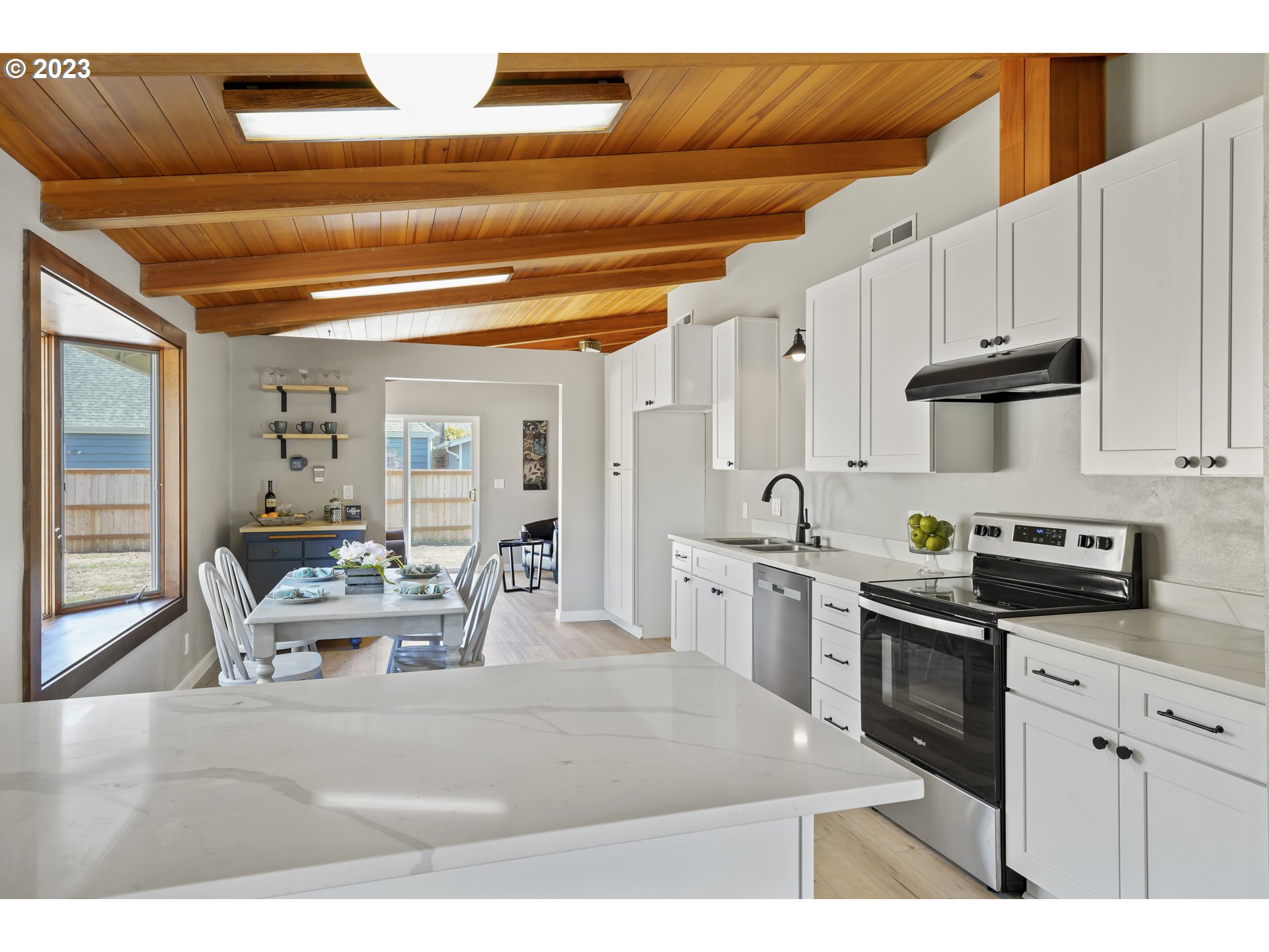 2232 24th Street Florence, OR 97439 - Photo 13 of 38 a kitchen with stainless steel appliances kitchen island granite countertop a sink and cabinets