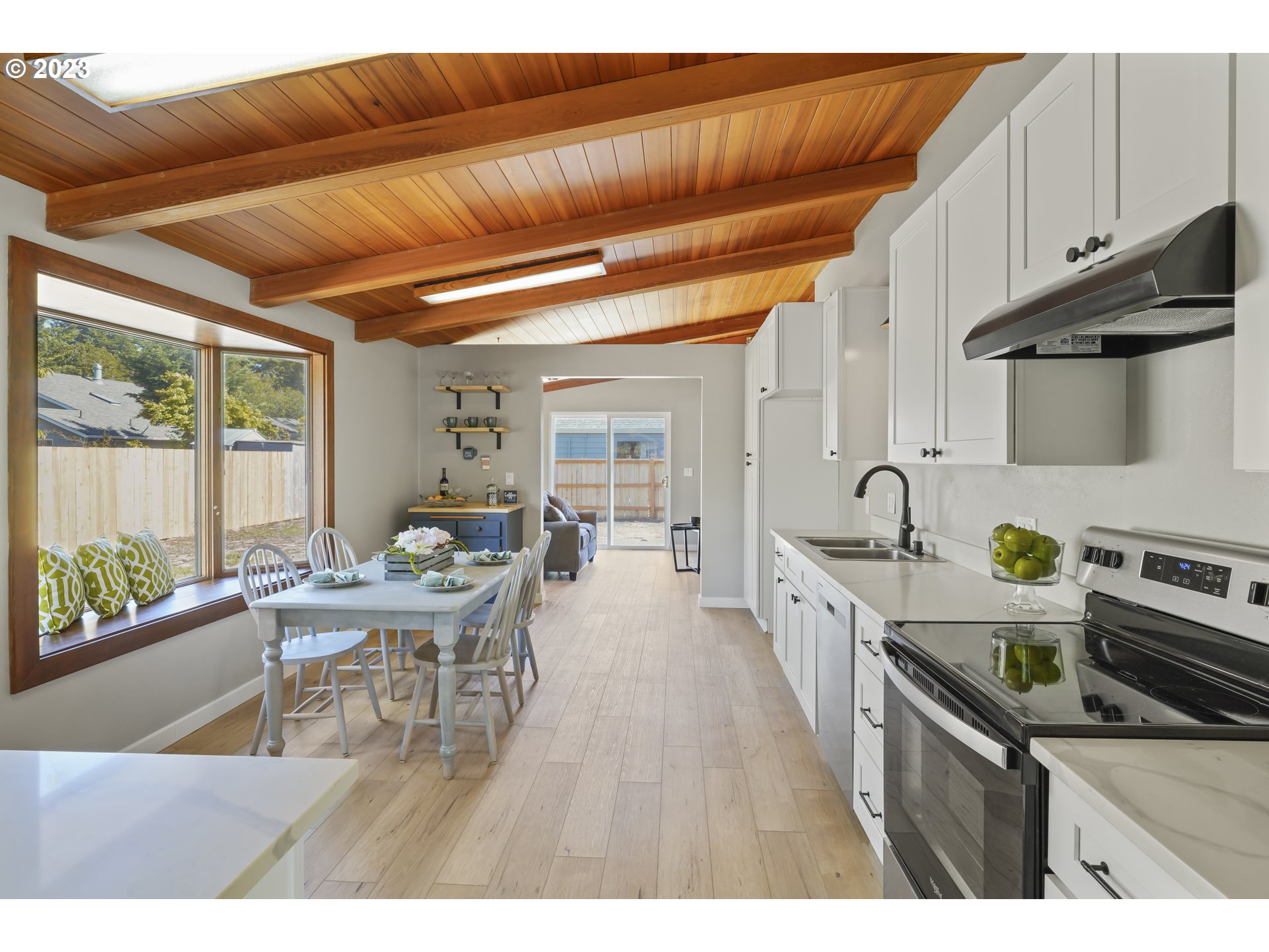 2232 24th Street Florence, OR 97439 - Photo 14 of 38 a open kitchen with stainless steel appliances granite countertop a stove a sink dishwasher and cabinets with wooden floor