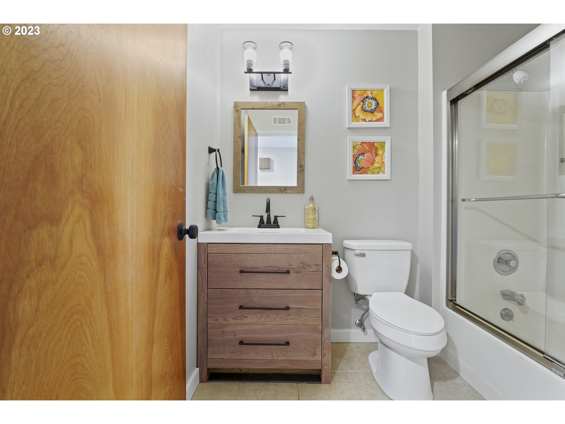 2232 24th Street Florence, OR 97439 - Photo 26 of 38 a bathroom with a toilet a sink a vanity and mirror