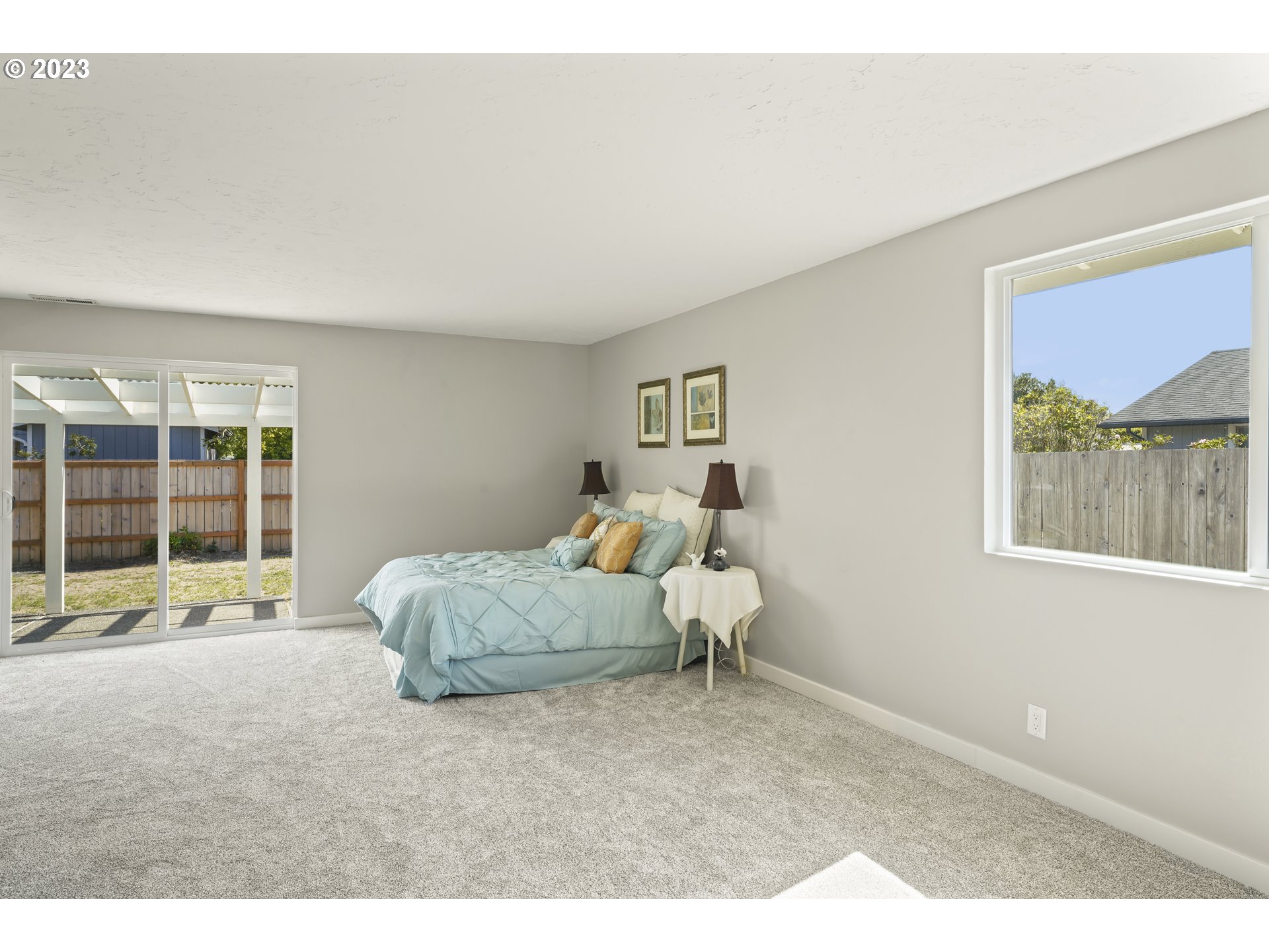 2232 24th Street Florence, OR 97439 - Photo 27 of 38 a spacious bedroom with a bed and a large window