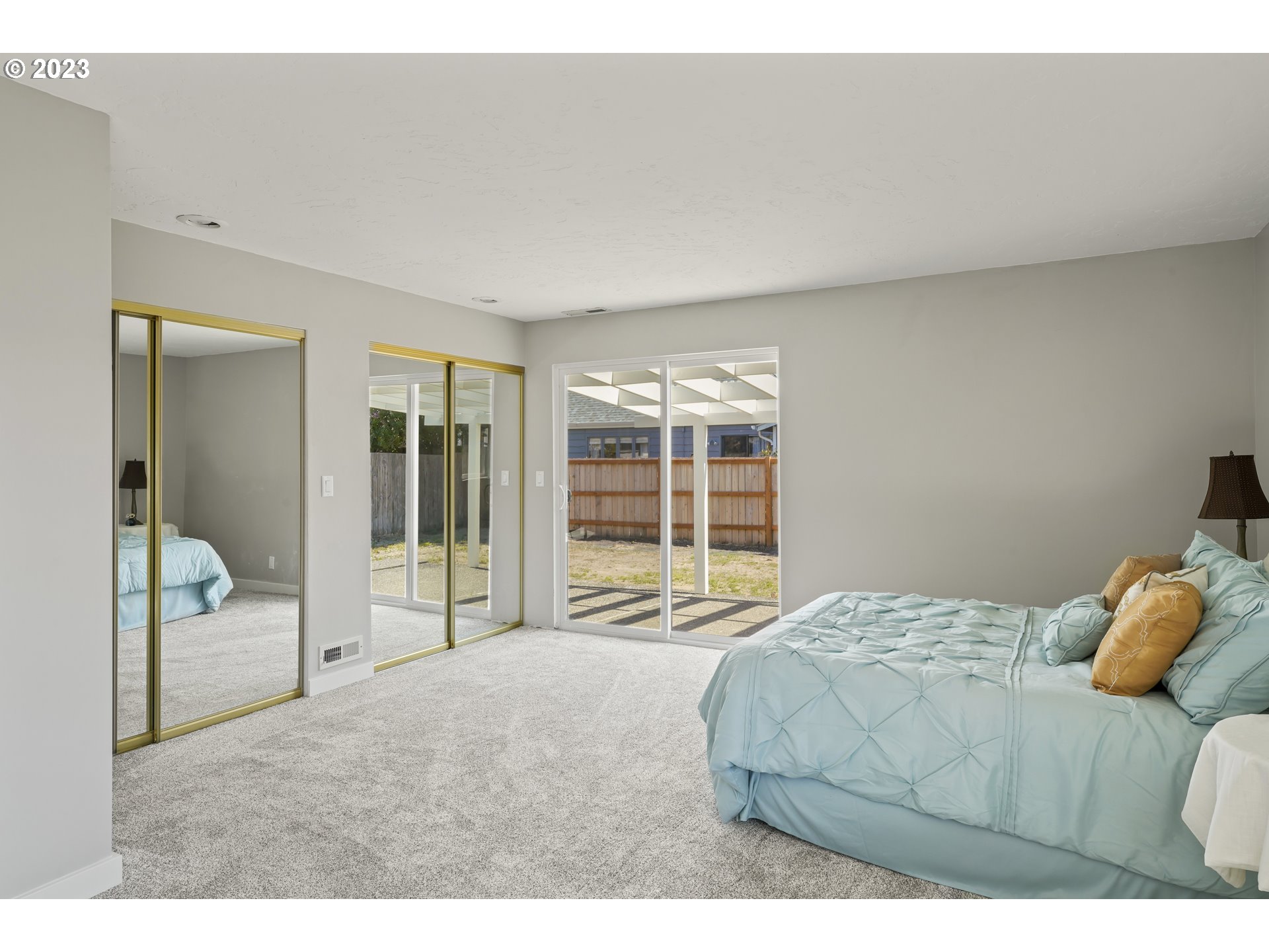 2232 24th Street Florence, OR 97439 - Photo 28 of 38 a bedroom with a bed and glass door