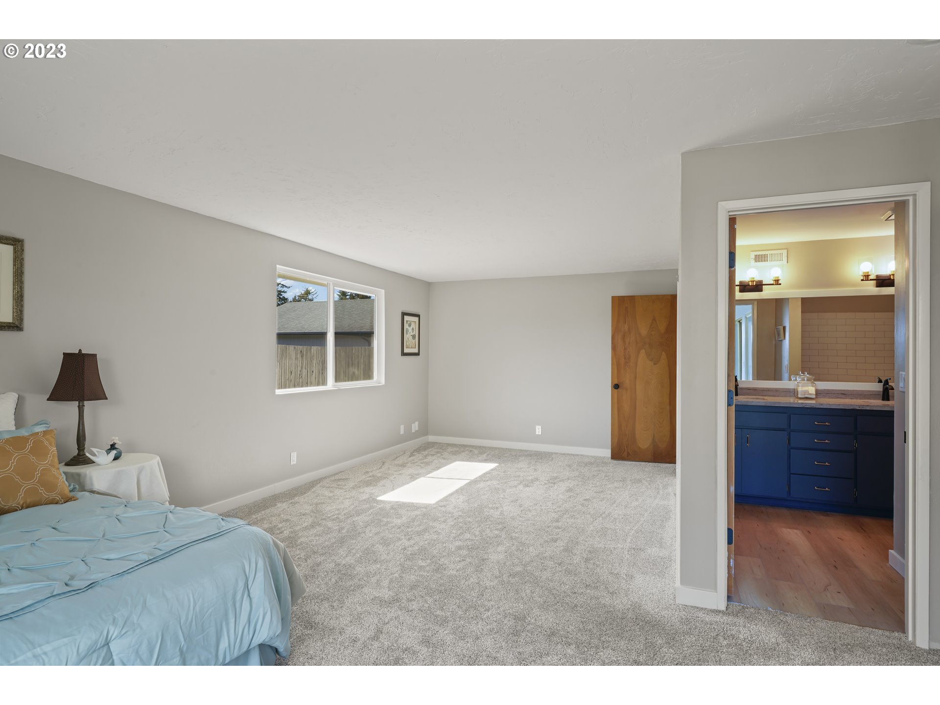 2232 24th Street Florence, OR 97439 - Photo 29 of 38 a bedroom with a bed and a mirror