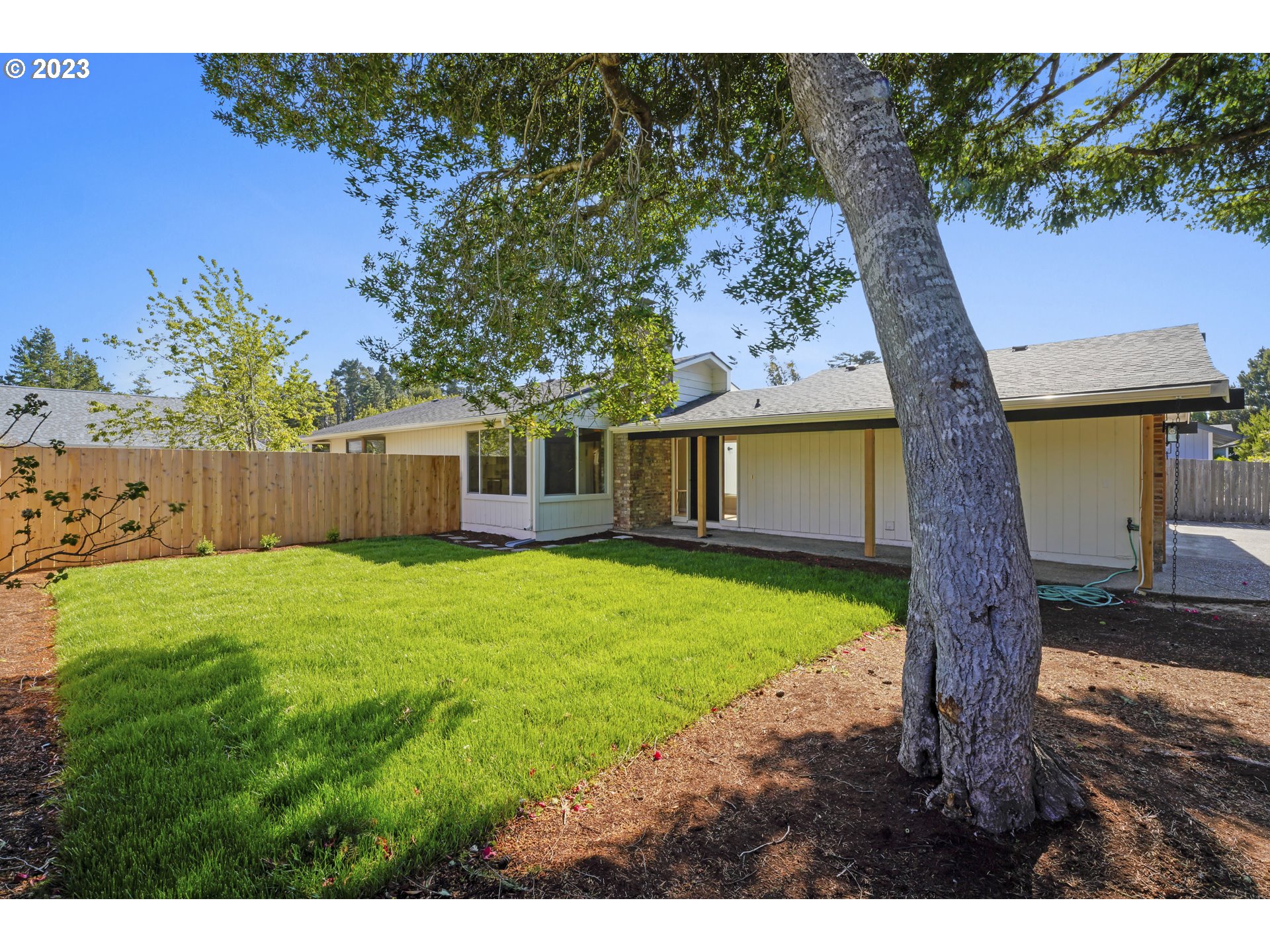 2232 24th Street Florence, OR 97439 - Photo 3 of 38 a view of a house with a garden