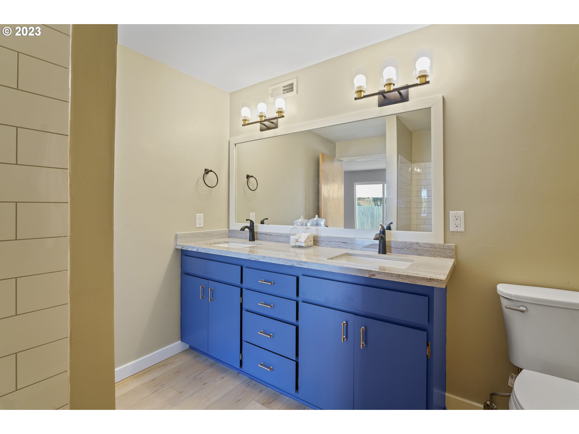 2232 24th Street Florence, OR 97439 - Photo 32 of 38 a bathroom with a granite countertop sink mirror and toilet