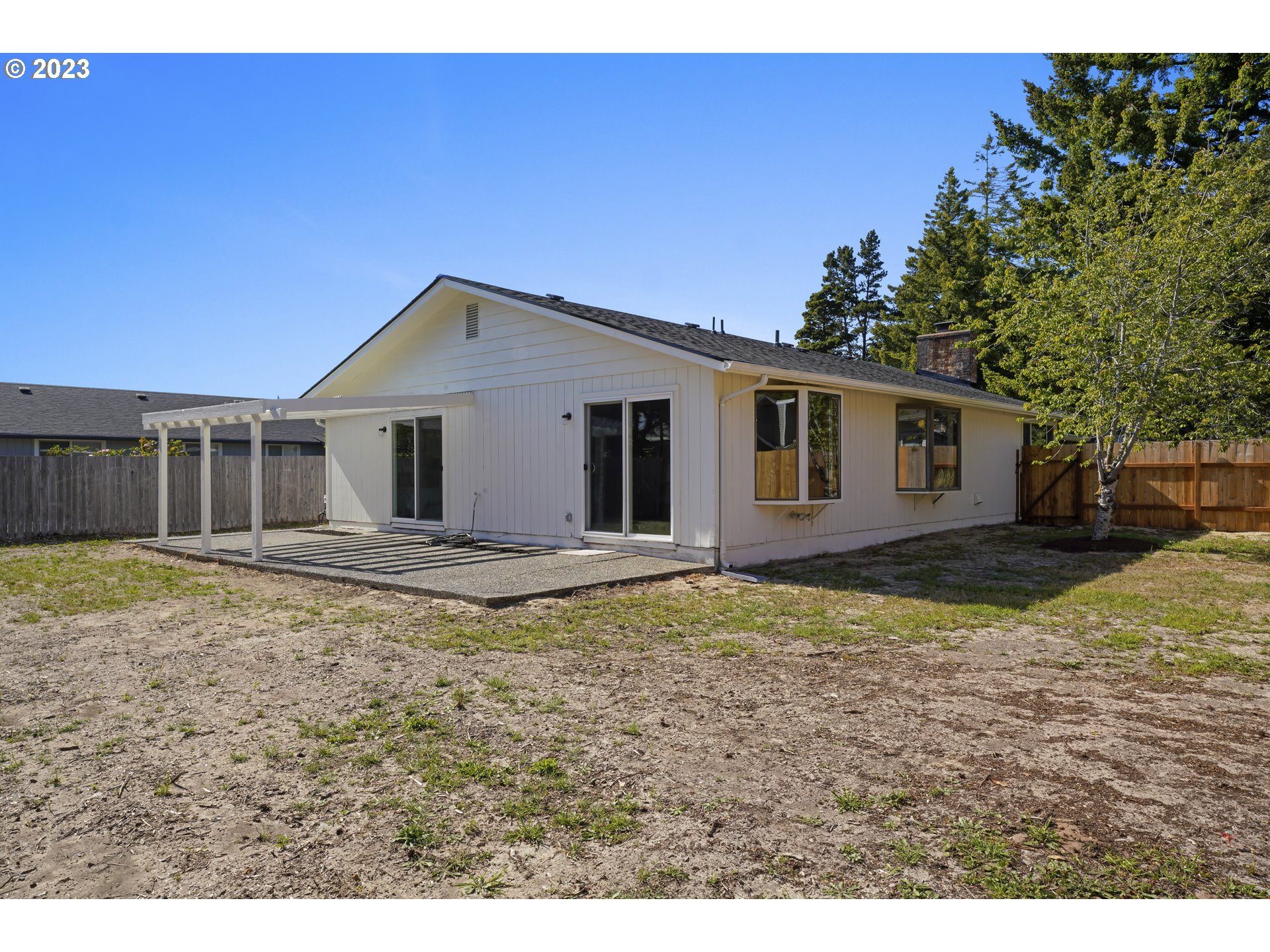 2232 24th Street Florence, OR 97439 - Photo 34 of 38 a house with trees in the background