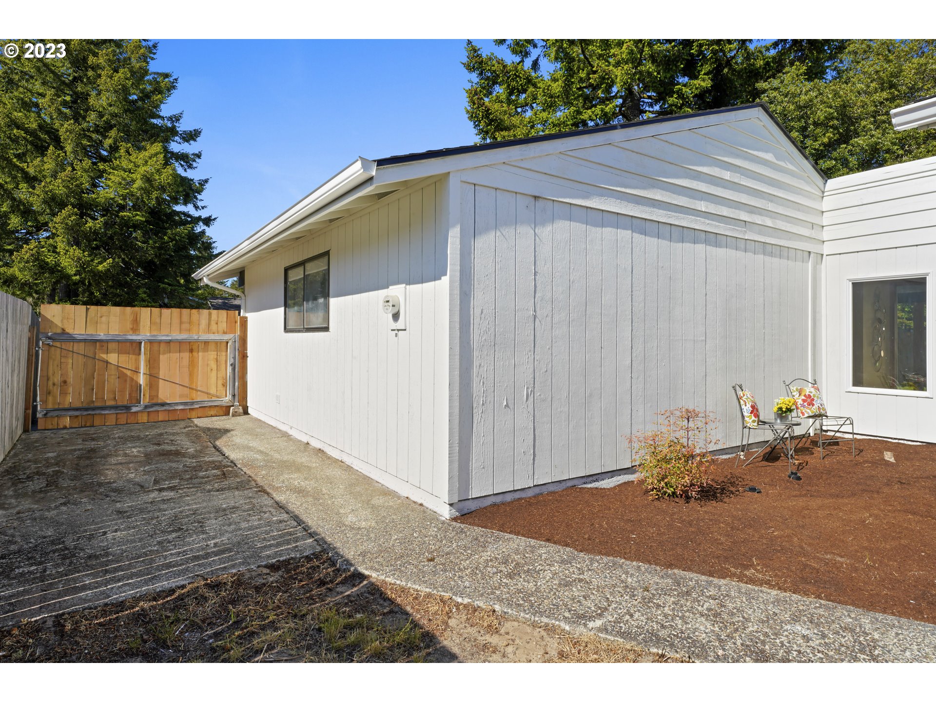 2232 24th Street Florence, OR 97439 - Photo 36 of 38 a backyard of a house with yard and garage