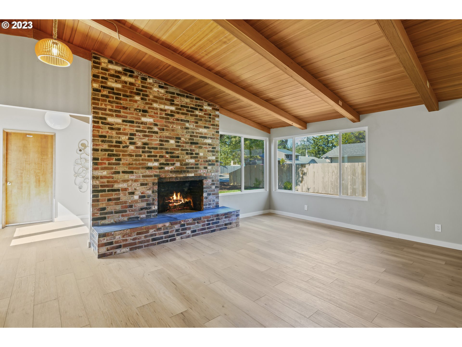 2232 24th Street Florence, OR 97439 - Photo 9 of 38 a view of an empty room with wooden floor fireplace and a window