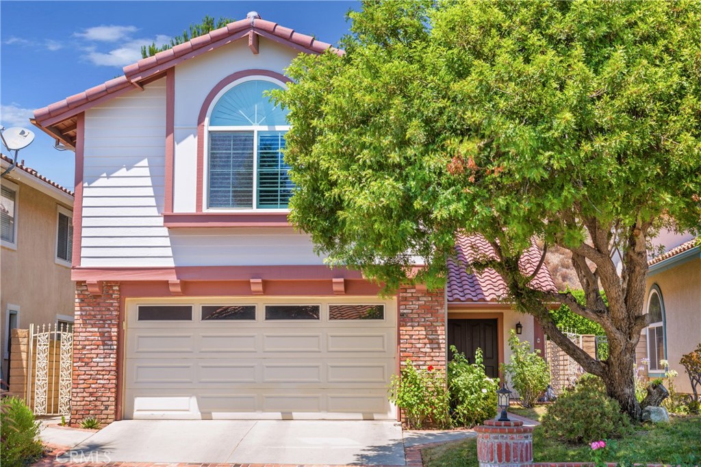 19905 Eagle Ridge Lane Porter Ranch, CA 91326 - Photo 1 of 1 a front view of a house with a yard