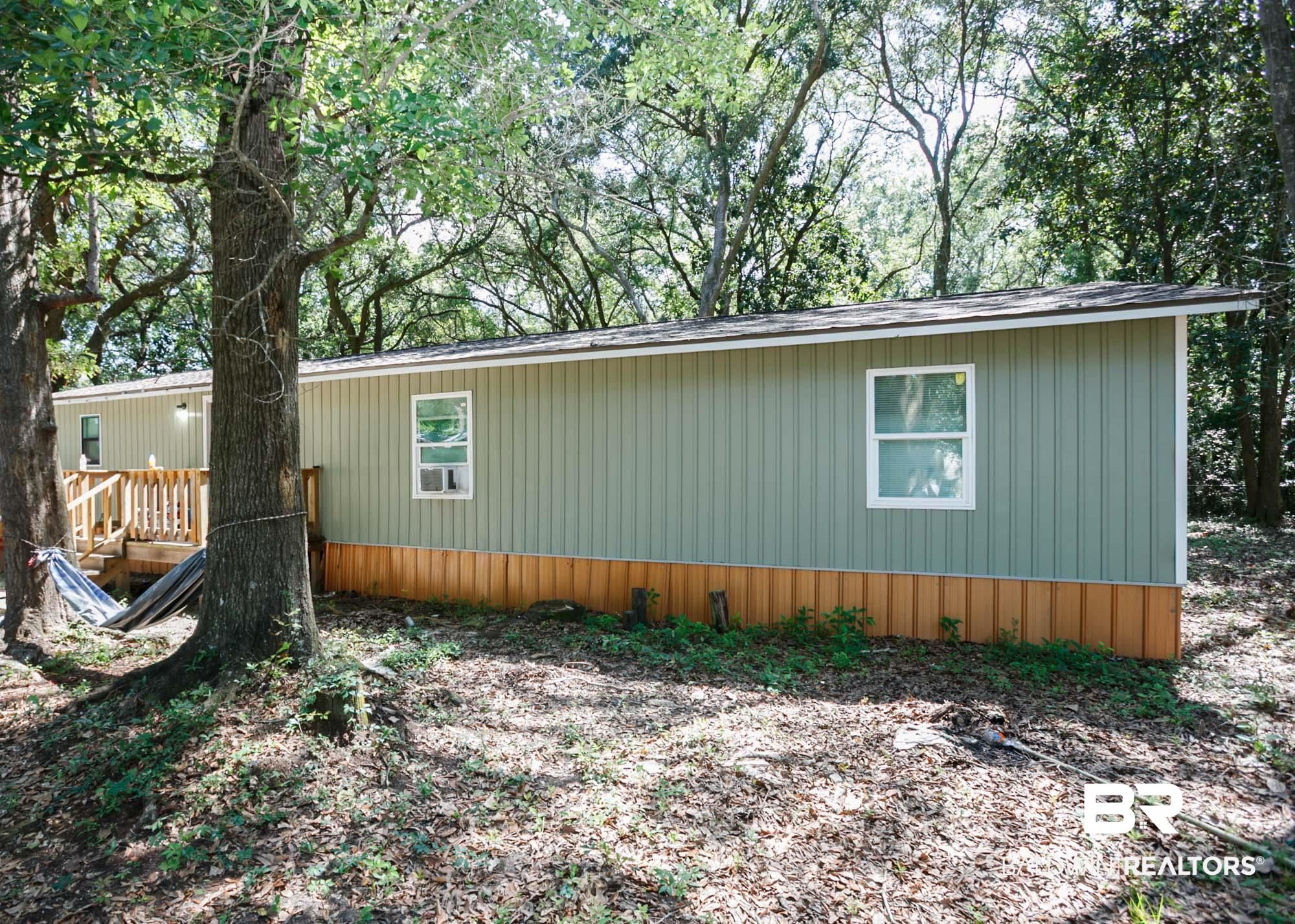 11998 Workman Avenue Foley, AL 36535 - Photo 5 of 59 View of side of property with a wooden deck