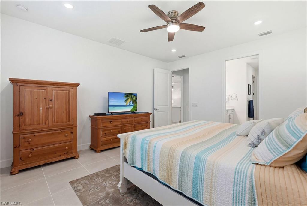 18364 Ridgeline Drive Estero, FL 33928 - Photo 22 of 50 a bedroom with a bed and a dresser