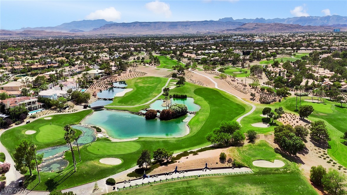 8981 Rivers Edge Drive Las Vegas, NV 89117 - Photo 65 of 69 An aerial perspective reveals a vibrant golf course community, bordered by majestic mountains.