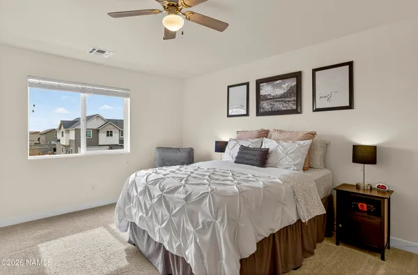 a bedroom with a bed and a television