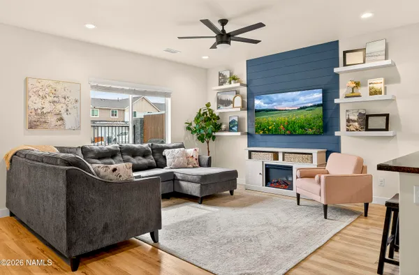 a living room with fireplace furniture and a flat screen tv