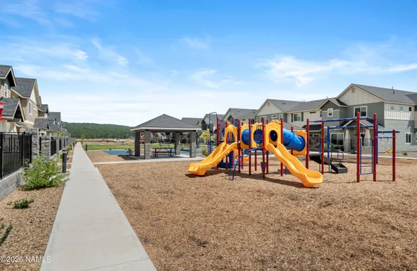 a view of a park with swings and slides