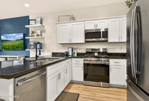 a kitchen with stainless steel appliances granite countertop a stove and a sink